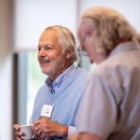 Alumni talking at the Grand Forum.